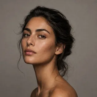 Three-quarter portrait of a woman with medium olive skin and dark wavy hair pulled back